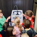 children looking the 3d printers